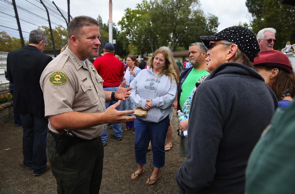 Lake County Sheriff Brian Martin, left, answers questions from residents about the evacuation and when they might be able to return home, at the evacuation center at the Napa County Fairground, in Calistoga, on Monday, September 14, 2015. (Christopher Chung/ The Press Democrat)