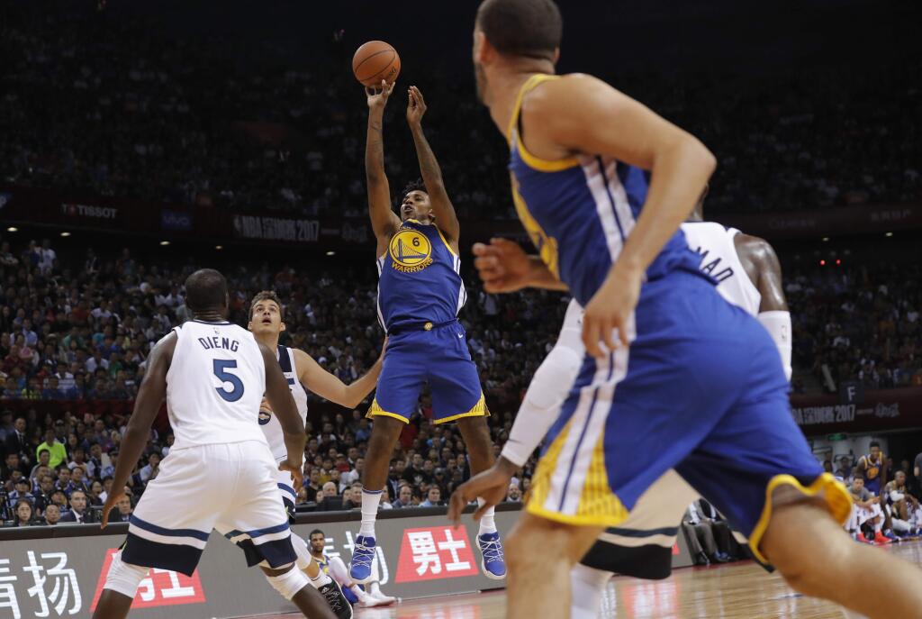 The Golden State Warriors' Nick Young, center, shoots against Minnesota Timberwolves in Shenzhen, China, Thursday, Oct. 5, 2017. (AP Photo/Kin Cheung)