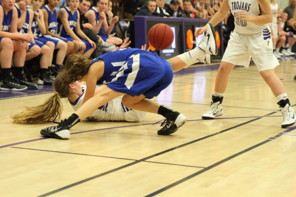 DWIGHT SUGIOKA/FOR THE ARGUS-COURIERPetaluma's Olivia Baldwin manages to make a pass to teammate Emily O'Keefe after scrambling for a loose ball in the T-Girls' overtime loss to Analy.