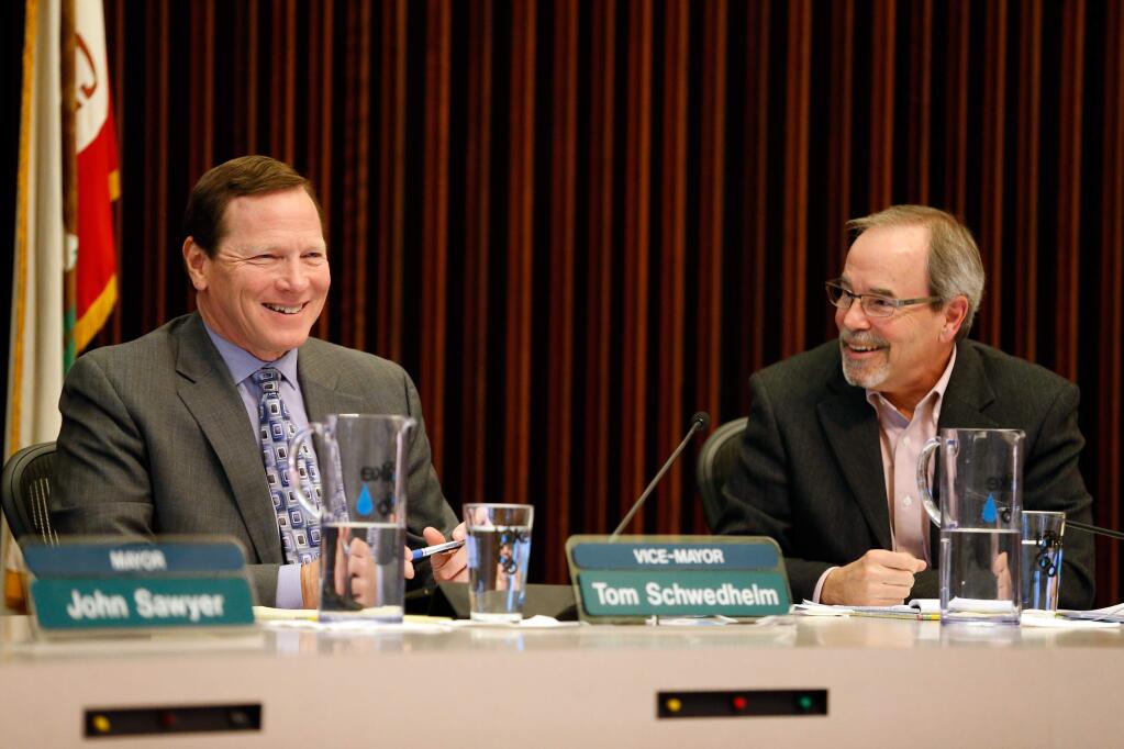 Santa Rosa City Councilman Tom Schwedhelm, left, and newly elected Mayor Chris Coursey talk during a council meeting in Santa Rosa on Tuesday, Dec. 6, 2016. (ALVIN JORNADA/ PD)