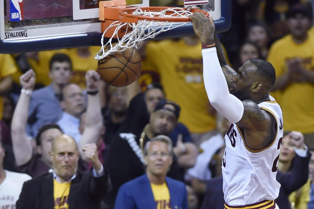 Cleveland Cavaliers forward LeBron James dunks against the Toronto Raptors during the first half of Game 5 of the NBA basketball Eastern Conference finals, Wednesday, May 25, 2016, in Cleveland. (Frank Gunn/The Canadian Press via AP)