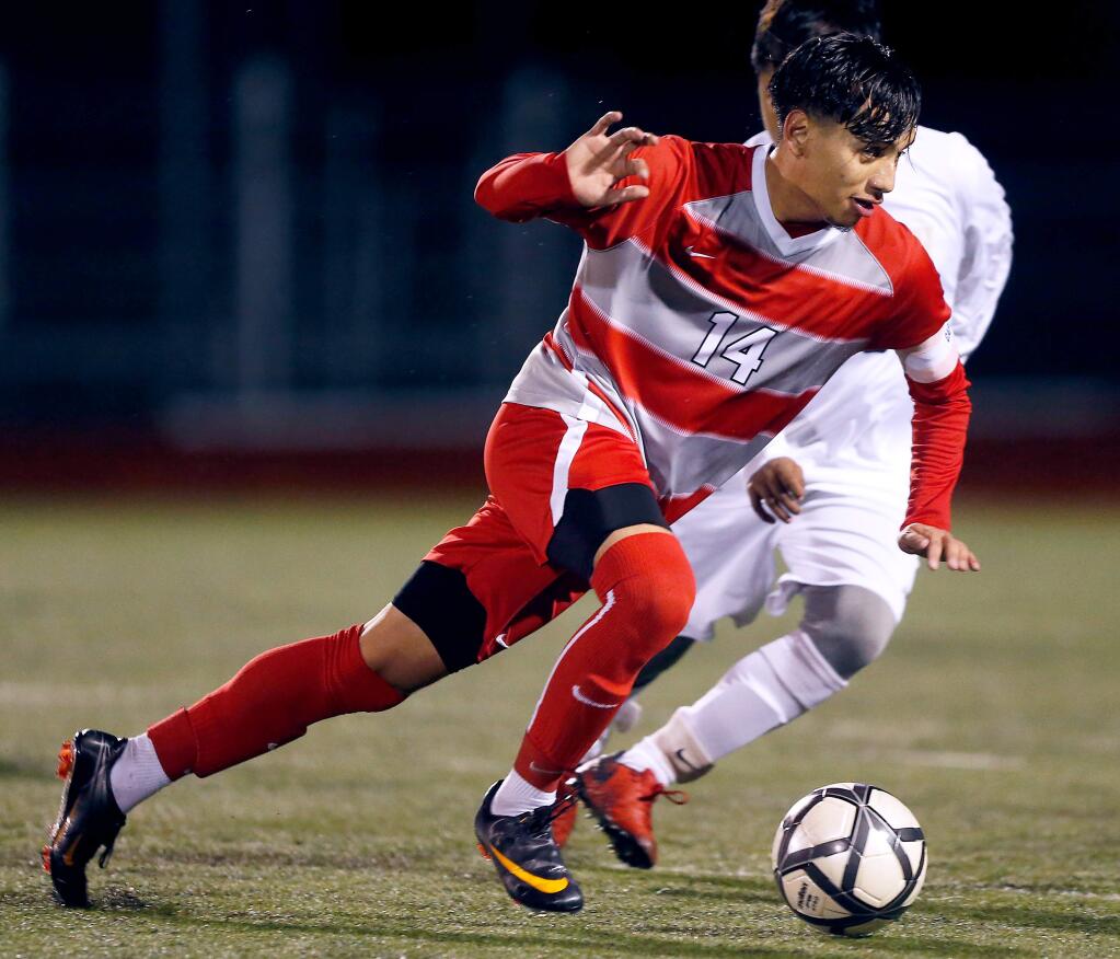 Montgomery's Alejandro Oliveras (14) takes control of the ball during the first half of the NCS Division 2 boys varsity soccer playoff match between Windsor and Montgomery high schools on Wednesday, February 13, 2019. (Alvin Jornada / The Press Democrat)