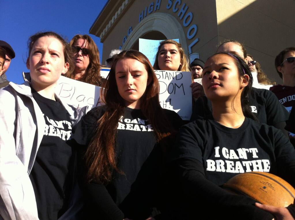 The Mendocino High School girls basketball team rallies outside the Fort Bragg hoops tournament after being banned for wearing shirts emblazoned with “I can't breathe” on Monday, Dec. 29, 2014. (BETH SCHLANKER / PD)