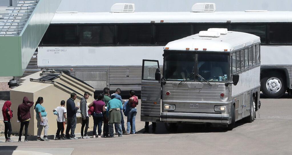 FILE - In this April 20, 2019 file photo, migrants are loaded onto a bus at the Border Patrol headquarters on Hondo Pass, in El Paso, Texas. The U.S. Border Patrol's apprehensions of migrants at the border with Mexico hit their highest level in more than a decade, as officials warned they don't have the money and resources to care for the surge of parents and children entering the country. Agents made 132,887 apprehensions in May 2019, the first time that apprehensions have topped 100,000 since April 2007. (Mark Lambie/The El Paso Times via AP File)