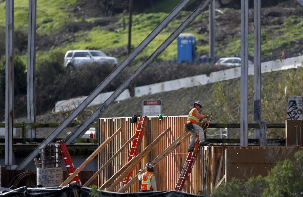 Employees from Shimmick Construction, contracted by the SMART agency, work to replace the Haystack Bridge over the Petaluma River on Wednesday, February 11, 2015 in Petaluma, California . (BETH SCHLANKER/ The Press Democrat)