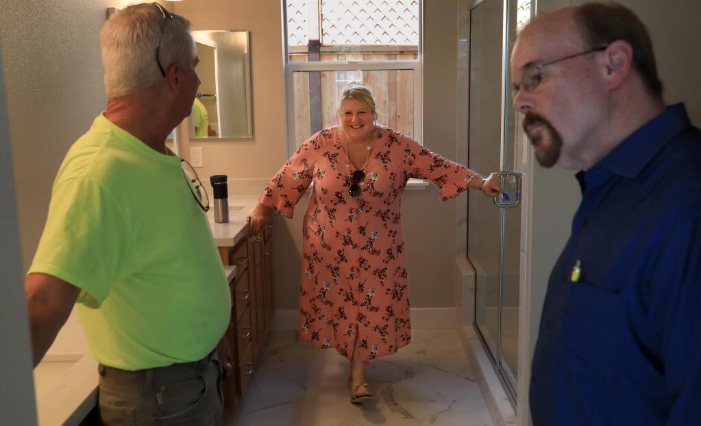 Craig Bartlett of Christopherson Builders, left, gives Tracy Kecskemeti and partner Tom Killfoile a walk through of their Tubbs fire rebuilt home in Coffey Park, Monday, September 23, 2019. (Kent Porter / The Press Democrat