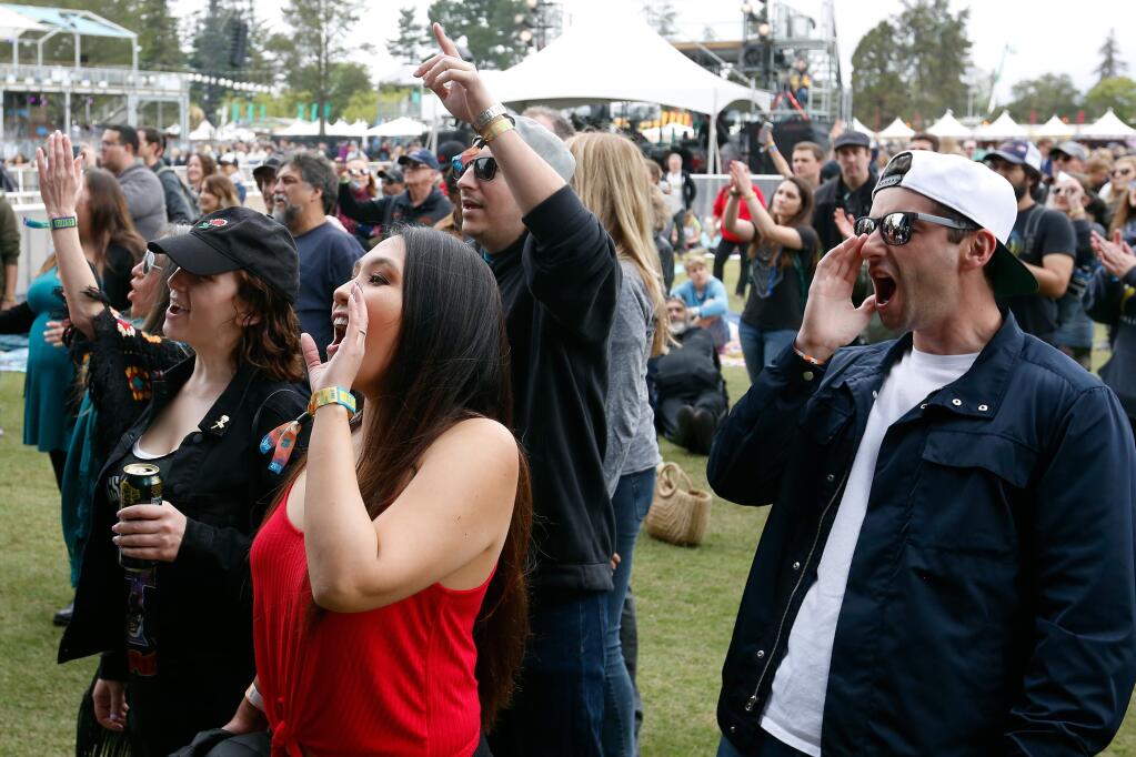Concertgoers Alex and Iris Elent, front, of San Mateo and their friends Hanna Yanover and Brandon Avanzato of Walnut Creek cheer for RIVVRS as the band performs on the JaM Cellars Stage during the first day of BottleRock Napa Valley, in Napa, California, on Friday, May 25, 2018. (Alvin Jornada / The Press Democrat)