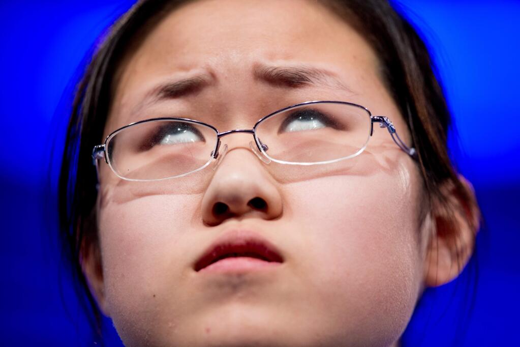 Sophia Han, 14, of Tianjin, China, thinks about how to spell her word 'vermicide' during the 2015 Scripps National Spelling Bee, Wednesday, May 27, 2015, in Oxon Hill, Md. (AP Photo/Andrew Harnik)