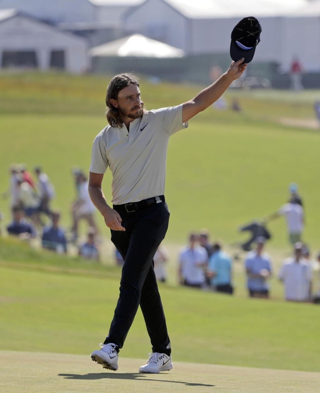 Tommy Fleetwood of England, waves to spectators after finishing the final round of the U.S. Open Golf Championship, Sunday, June 17, 2018, in Southampton, N.Y. (AP Photo/Frank Franklin II)