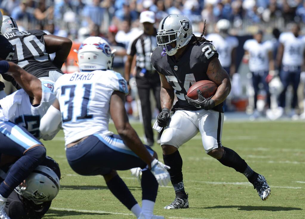 Oakland Raiders running back Marshawn Lynch (24) runs the ball against Tennessee Titans free safety Kevin Byard (31) in the first half of an NFL football game Sunday, Sept. 10, 2017, in Nashville, Tenn. (AP Photo/Mark Zaleski)