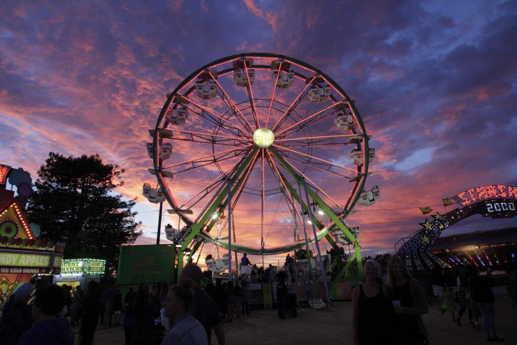 The lights come up as the sun sets at the Sonoma-Marin Fair on Wednesday, June 24, 2015. (Jim Johnson/For the Argus-Courier)