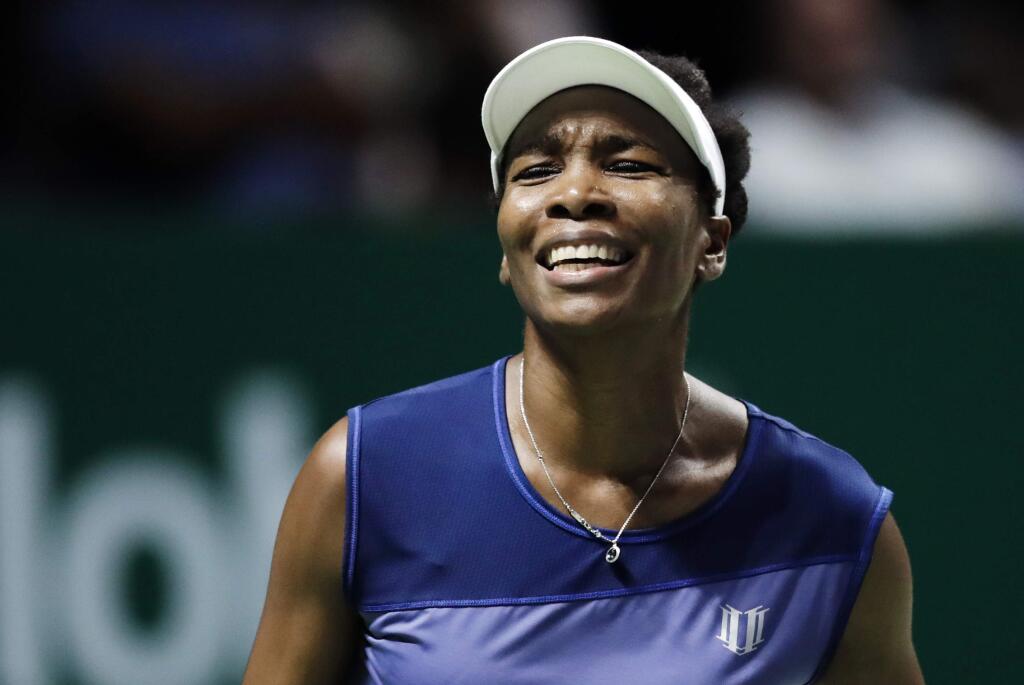 FILE - In this Oct. 28, 2017, file photo, Venus Williams, of the United States, reacts after conceding a point to Caroline Garcia, of France, during their semifinal match at the WTA tennis tournament in Singapore. Burglars hit the tennis star's Florida home, stealing $400,000 worth of goods while she was at the U.S. Open. Palm Beach Gardens police released a report Thursday, Nov. 16, 2017, about the burglary, which happened between Sept. 1 and 5. (AP Photo/Yong Teck Lim, File)