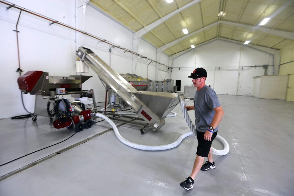 Brian Kobler prepares the new Healdsburg Custom Crush facility for the opening new week on Wednesday, August 6, 2014.