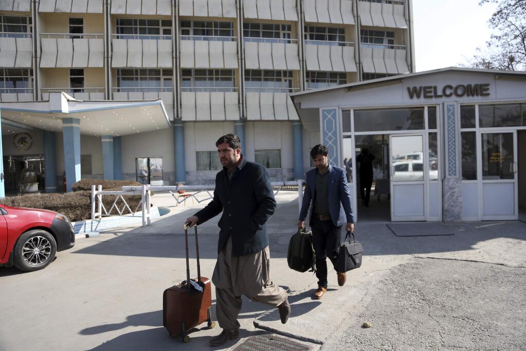 Guests of the hotel collect their luggage two days after the end of the siege from the Intercontinental Hotel after a deadly attack in Kabul, Afghanistan, Tuesday, Jan. 23, 2018. Survivors of the Taliban attack on Kabul's Intercontinental Hotel gave harrowing accounts on Monday of the 13-hour weekend standoff. The siege ended on Sunday with Afghan security forces saying they had killed the last of six Taliban militants who stormed the hotel in suicide vests late the previous night, looking for foreigners and Afghan officials to kill. (AP Photo/Rahmat Gul)