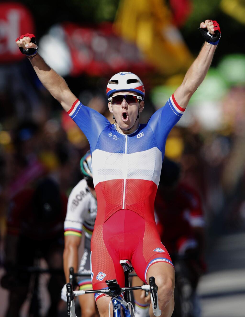 France's Arnaud Demare crosses the finish line to win the fourth stage of the Tour de France cycling race over 207.5 kilometers (129 miles) with start in Mondorf-les-Bains, Luxembourg, and finish in Vittel, France, , Tuesday, July 4, 2017. (AP Photo/Christophe Ena)
