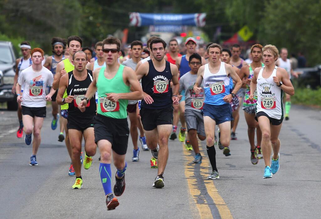Runners in the 10K event of the Kenwood Footrace take off from the start, in Kenwood, on Monday, July 4, 2016. (Christopher Chung/ The Press Democrat)
