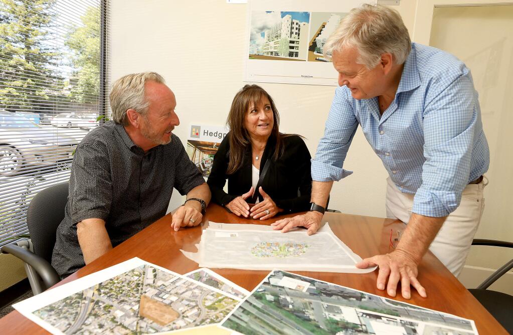From left, BoDean asphalt company owners Dean Soiland and his wife Belinda “Bo” talk with architect Warren Hedgpeth over plans for their new plant in southern Windsor. (Photo by John Burgess/The Press Democrat)