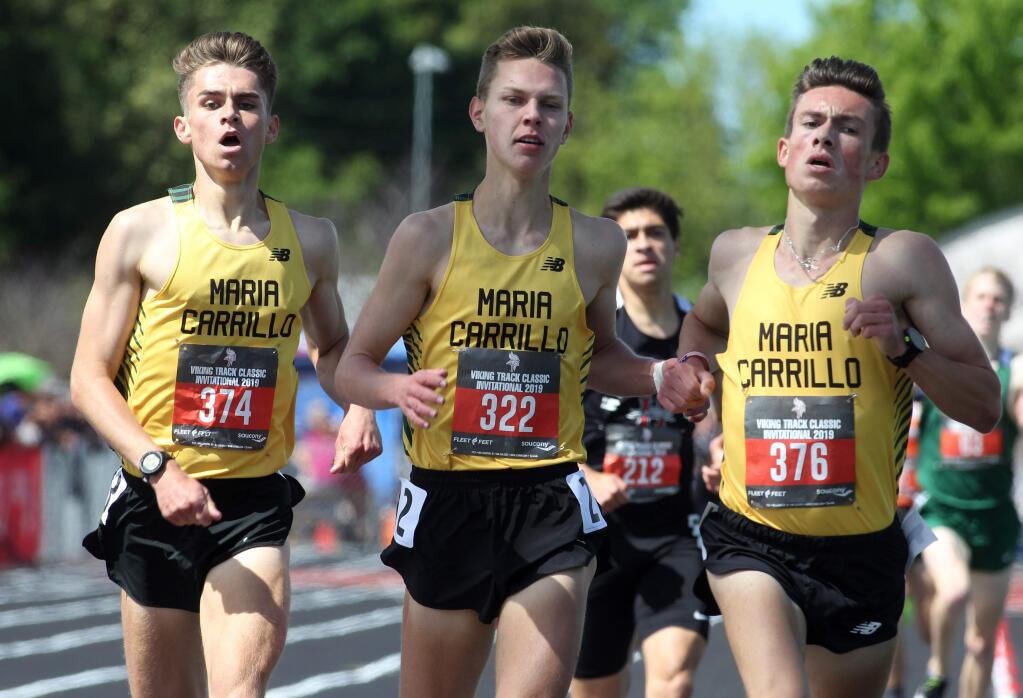 From right to left are Maria Carrillo's Colton Swinth (376), Pierce Kapustka (322) and Rory Smail (374), as Swinth wins and his teammates finish second and third in the 1,600-meter boys race during the Viking Track Classic at Montgomery High School in Santa Rosa on Saturday, April 20, 2019. (Photo by Darryl Bush / For The Press Democrat)