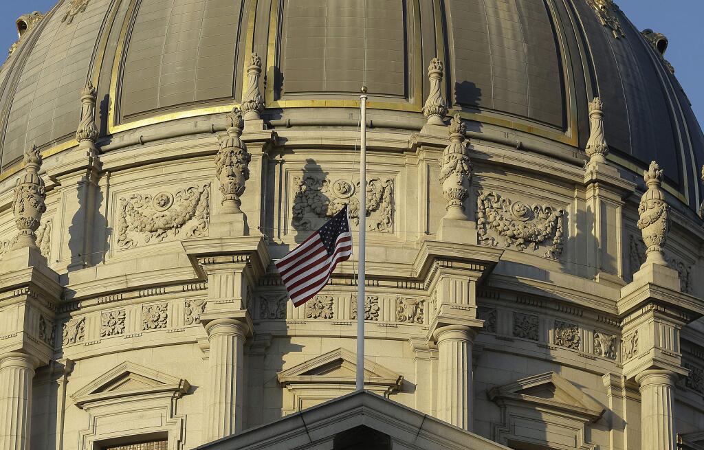 A flag flies at half-staff on the mayor's balcony at City Hall for Mayor Ed Lee in San Francisco, Tuesday, Dec. 12, 2017. Mayor Ed Lee, who oversaw a technology-driven economic boom in San Francisco that brought with it sky-high housing prices despite his commitment to economic equality, died suddenly early Tuesday at age 65. (AP Photo/Jeff Chiu)