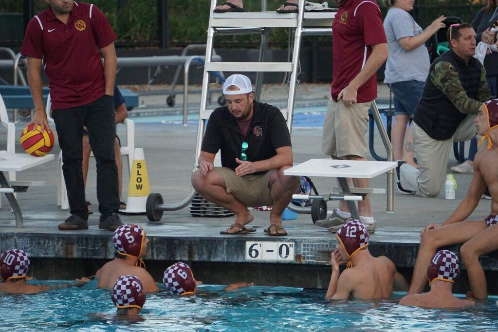 Cardinal Newman water polo players during a break in the action this season.