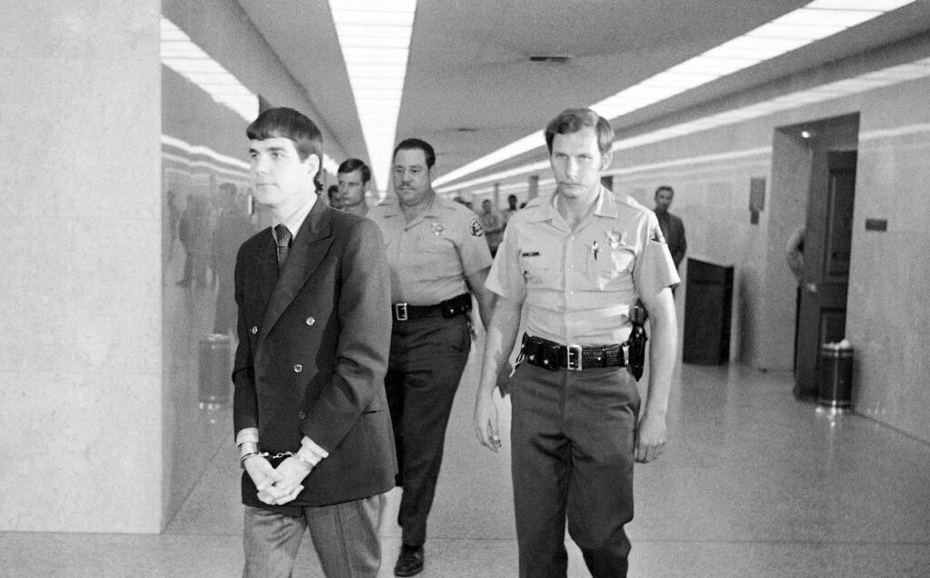 FILE - In this Oct. 12, 1971 file photo, Charles 'Tex' Watson, left, is led back to jail from a courtroom after he was convicted of seven counts of first degree murder and one of conspiracy to commit murder in the Tate-LaBianca slayings, in Los Angeles. California officials have denied parole for Watson, the self-described 'right-hand man' of murderous cult leader Charles Manson. The decision came Thursday, Oct. 27, 2016, at the 17th parole hearing for Watson and 47 years after he helped plan and participated in the slayings of pregnant actress Sharon Tate and six others in 1969. (AP Photo/George Brich, File)