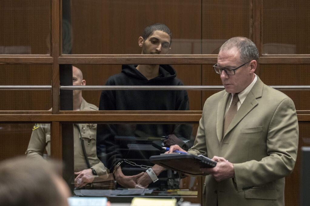 Tyler Barriss, center, stands near public defender Mearl Lottman as he appears for an extradition hearing at Los Angeles Superior Court on Wednesday, Jan. 3, 2018, in Los Angeles. Barriss, accused of making a hoax emergency call that led to the fatal police shooting of a Kansas man, told a judge Wednesday he would not fight efforts to send him to Wichita to face charges. (Irfan Khan /Los Angeles Times via AP, Pool)