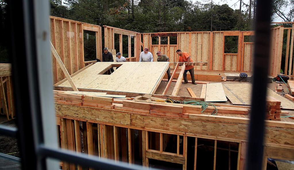 Carpenters raise a wall on a new housing development off Kawana Terrace in Santa Rosa, Wednesday March 9, 2016. (Kent Porter / Press Democrat ) 2016