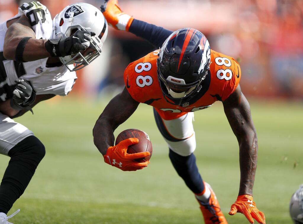 Broncos wide receiver Demaryius Thomas is hit by Raiders linebacker Derrick Johnson last Sunday in Denver. With only two sacks as a team, Johnson realizes something has to change. (AP Photo/Jack Dempsey)