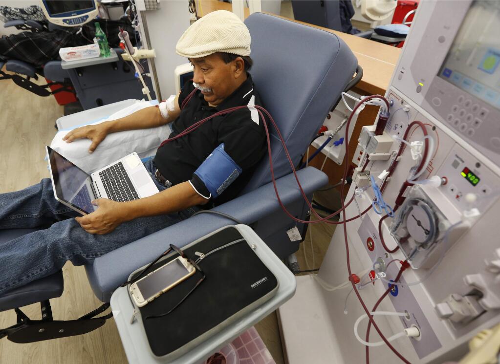 In this photo taken Monday, Sept. 24, 2018, Adrian Perez undergoes dialysis at a DaVita Kidney Care clinic in Sacramento. (AP Photo/Rich Pedroncelli)