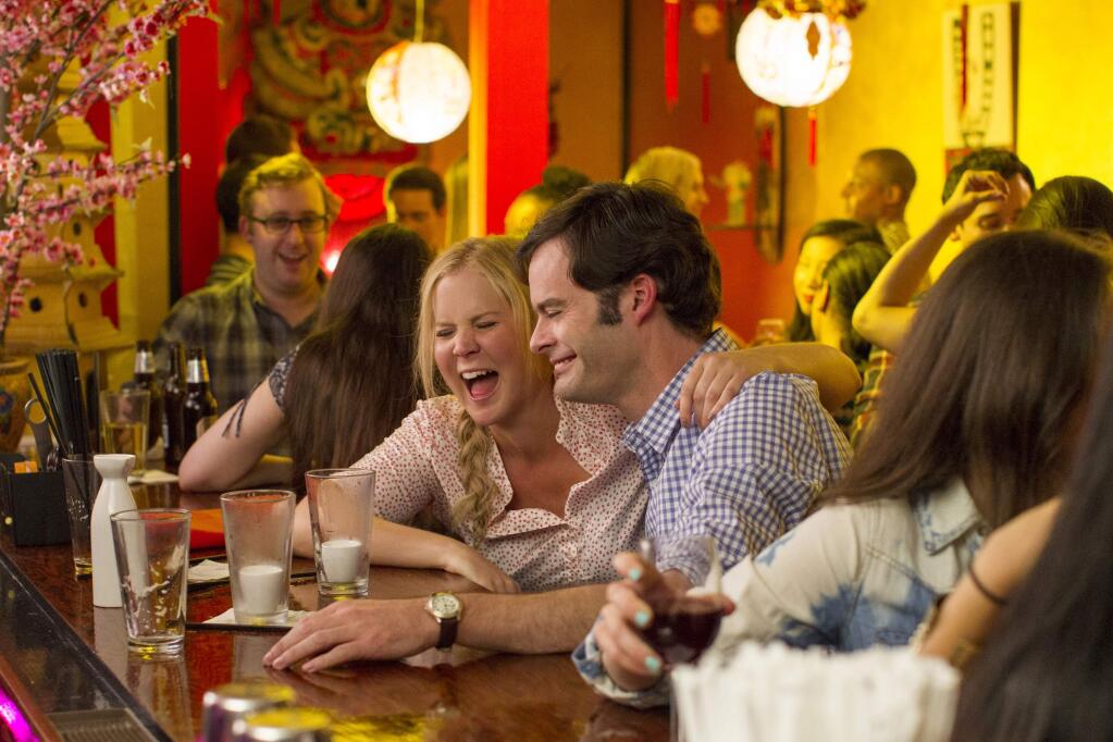 This photo provided by Universal Pictures shows, Amy Schumer , left, as Amy, and Bill Hader as Aaron, on a date in 'Trainwreck,' the new comedy from director/producer Judd Apatow. The movie releases in the U.S. on July 17, 2015. (Mary Cybulski/Universal Pictures via AP)