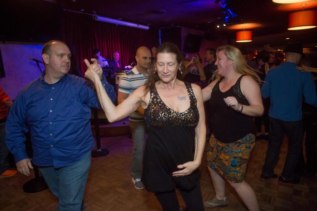 Couples move to the sounds of Braulio Barrera & Somos el Son during Santa Rosa Salsa's 16th anniversary party weekend at the Flamingo Conference Resort & Spa in Santa Rosa Sunday, January 16, 2017. (Jeremy Portje / For The Press Democrat)