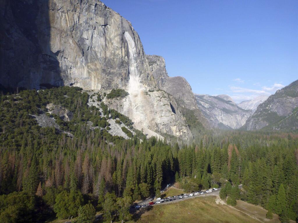 This Thursday, Sept. 28, 2017 photo provided by The National Park Service shows a rock fall off the iconic El Capitan rock formation in Yosemite National Park, Calif. A massive new rock fall hit Yosemite National Park on Thursday, cracking with a thundering roar off the iconic El Capitan rock formation and sending huge plumes of white dust surging through the valley floor below. (The National Park Service via AP)