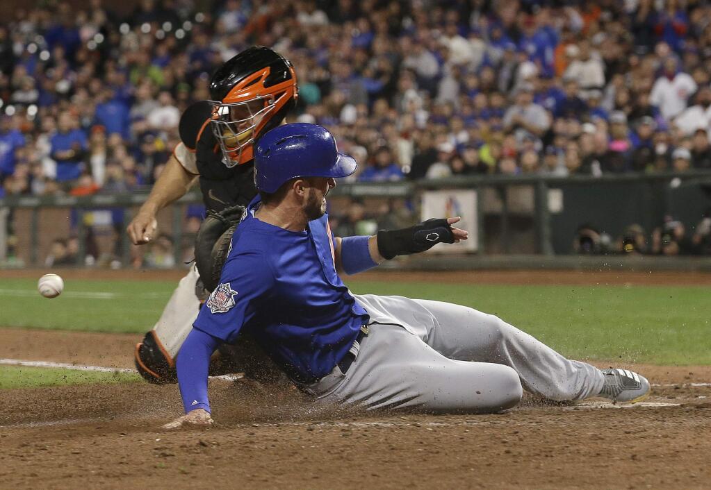 Chicago Cubs' Kris Bryant, bottom, scores past San Francisco Giants catcher Nick Hundley during the eighth inning of a baseball game in San Francisco, Tuesday, Aug. 8, 2017. (AP Photo/Jeff Chiu)