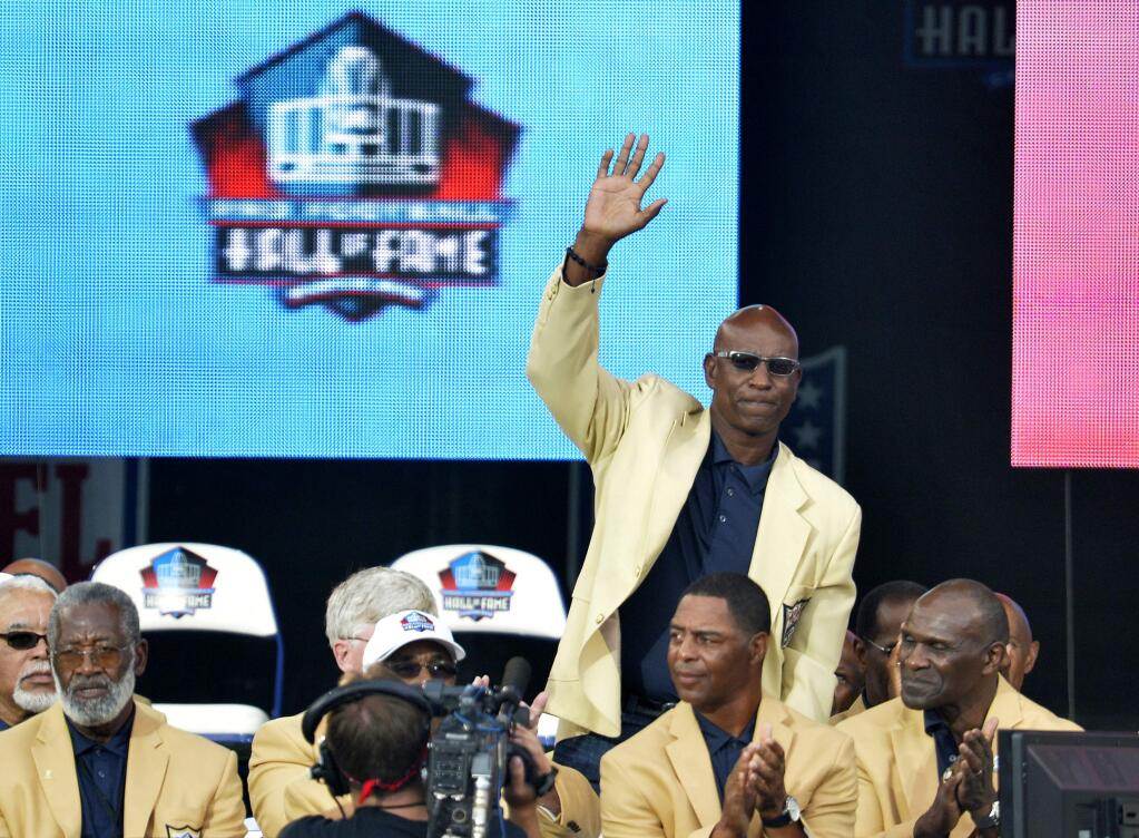 In this Aug. 2, 2014, file photo, enshrinee Eric Dickerson is introduced during the Pro Football Hall of Fame enshrinement ceremony, in Canton, Ohio. A group of Pro Football Hall of Famers is demanding health insurance coverage and a share of NFL revenues or else those former players will boycott the induction ceremonies. In a letter sent to NFL Commissioner Roger Goodell, NFLPA Executive Director DeMaurice Smith and Hall of Fame President David Baker - and obtained by The Associated Press - 21 Hall of Fame members cited themselves as 'integral to the creation of the modern NFL, which in 2017 generated $14 billion in revenue.' Among the signees were Eric Dickerson. (AP Photo/David Richard, File)