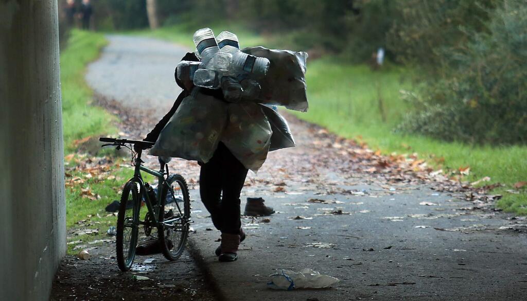 A homeless woman, who was part of the homeless count in Santa Rosa, Friday Jan. 17, 2017 collects recyclables on the Santa Rosa Creek Trail in Santa Rosa the woman would not give her name. (Kent Porter / Press Democrat) 2017