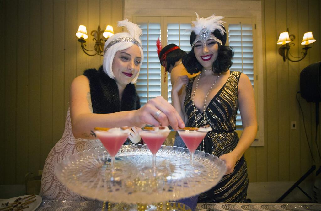 Twins Kristen and Lauren Geoffrey of Hopmonk Tavern put the finishing touches on their 'All That Jazz' cocktail. Martini Madness, that Sonoma event that invites local bartenders to prepare and serve daring and original martini concoctions, was held at Saddles, in MacArthur Place, on Friday, January 19. Some participants adopt a theme, complete with costumes and musical accompaniment, while others focus entirely on the making of a superlative cocktail. Attendees sipped mini-martini glasses filled with liquids of varying colors and then voted for their favorites. (Photo by Robbi Pengelly/Index-Tribune)