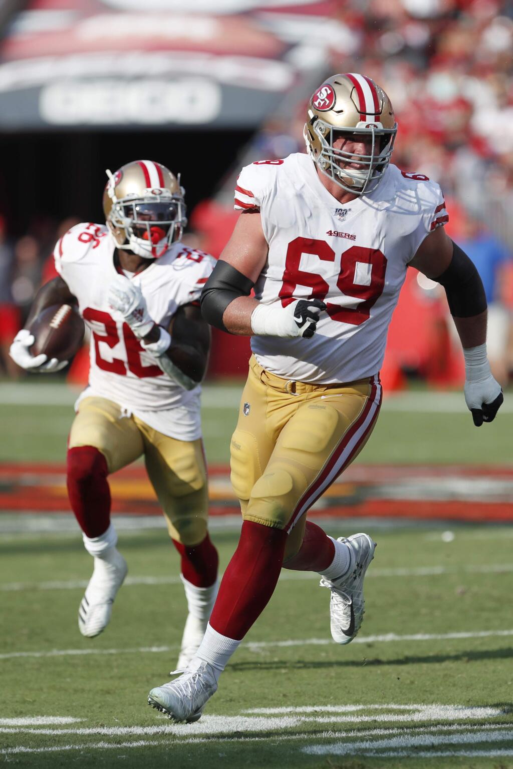 San Francisco 49ers offensive tackle Mike McGlinchey, right, looks to block for running back Tevin Coleman against the Tampa Bay Buccaneers during the first half, Sunday, Sept. 8, 2019, in Tampa, Fla. (AP Photo/Mark LoMoglio)