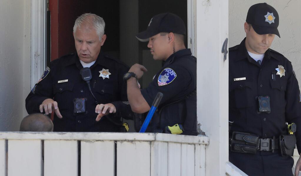 Santa Rosa police officers Garrett Berg questions a man who was involved in a an accident involving a two-year-old girl on Range Avenue in Santa Rosa on Thursday, July 11, 2019. (KENT PORTER/ PD)