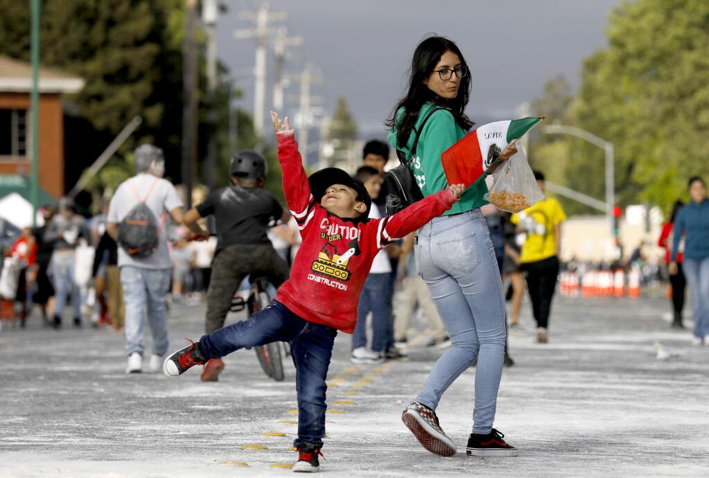 Yamilet Reyes, 17, and her brother Haziel, 3, attend the Cinco de Mayo celebration at the Roseland Village Shopping Center in Santa Rosa on Sunday, May 5, 2019. (Beth Schlanker/The Press Democrat)