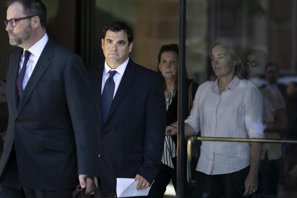 John Vandemoer, center, Stanford's former sailing coach, leaves court after pleading guilty in a college admissions scandal, in Boston, June 12, 2019. Stanford's boating troubles stem from the work of Singer, the private college consultant who collected millions of dollars in payments from wealthy parents and paid college coaches and athletic administrators to designate non-athletes as recruits for admissions purposes at elite universities. (Katherine Taylor/The New York Times)