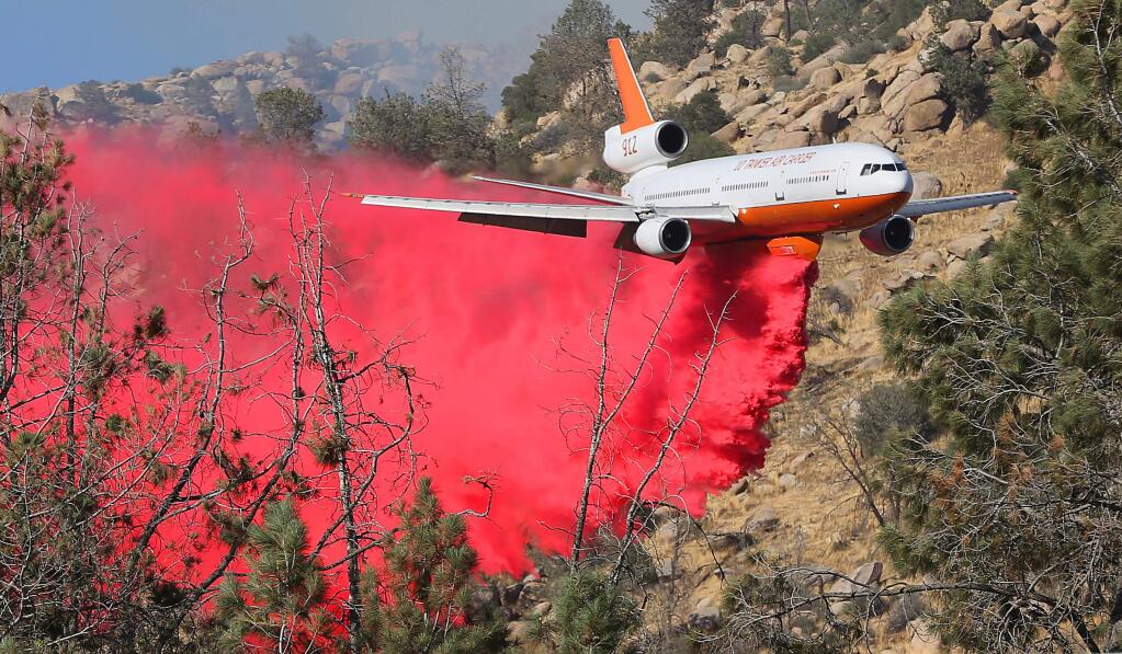 The 10 Tanker Air Carrier DC-10 drops a load of fire retardant on the Erskine fire near Lake Isabella, Calif., Thursday, June 23, 2016. It carries 11,600 gallons of fire retardant per load. Multiple resources were called to battle the blaze. (Casey Christie/The Bakersfield Californian via AP)