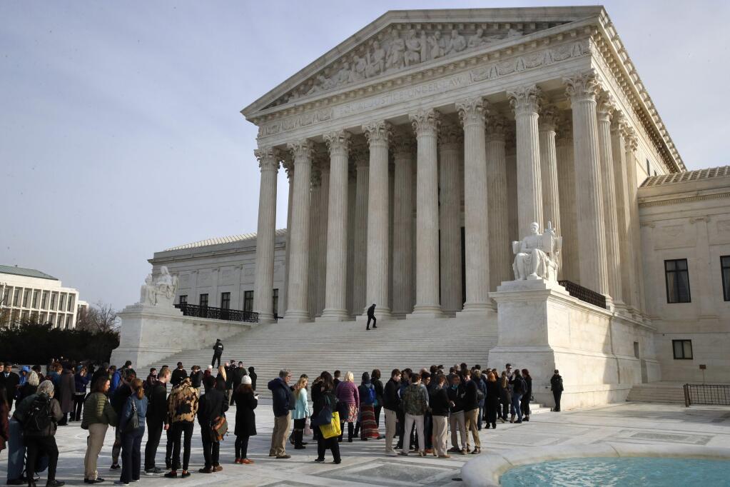 People stand in line to enter the Supreme Court on Monday, Dec. 4, 2017, in Washington. (AP Photo/Jacquelyn Martin)