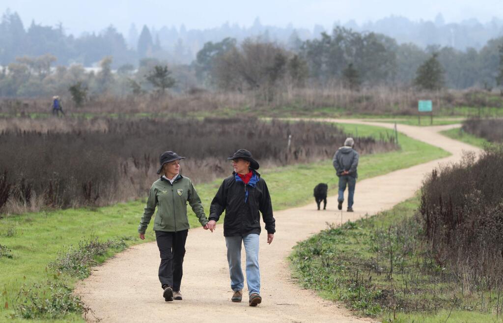 Sonoma County Regional Parks volunteer Sarah Reid walks with John Reid along the Laguna de Santa Rosa Trail, near Sebastopol in 2012. (CHRISTOPHER CHUNG/ PD FILE)