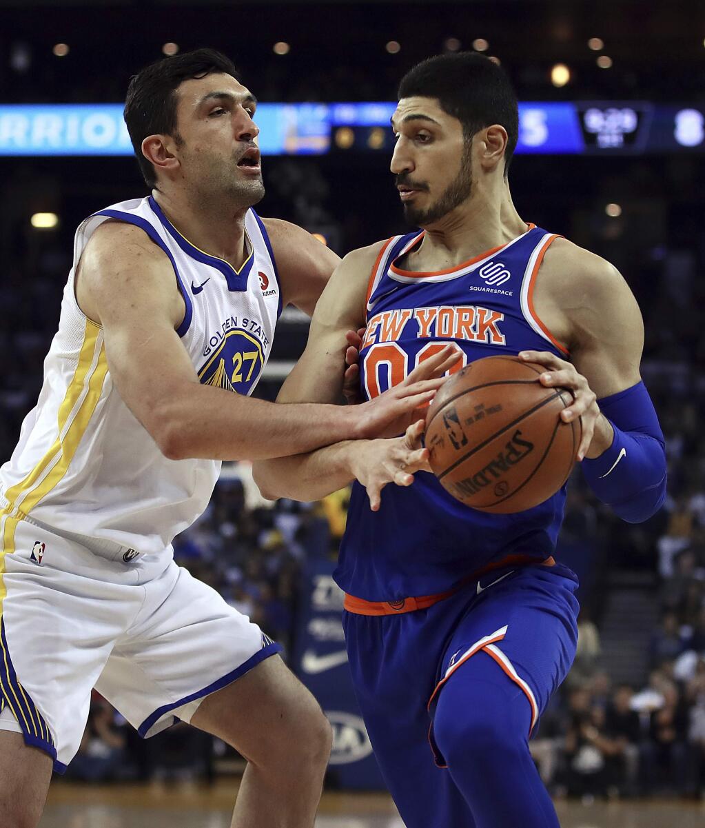 New York Knicks center Enes Kanter, right, drives the ball against Golden State Warriors center Zaza Pachulia during the first half Tuesday, Jan. 23, 2018, in Oakland. (AP Photo/Ben Margot)