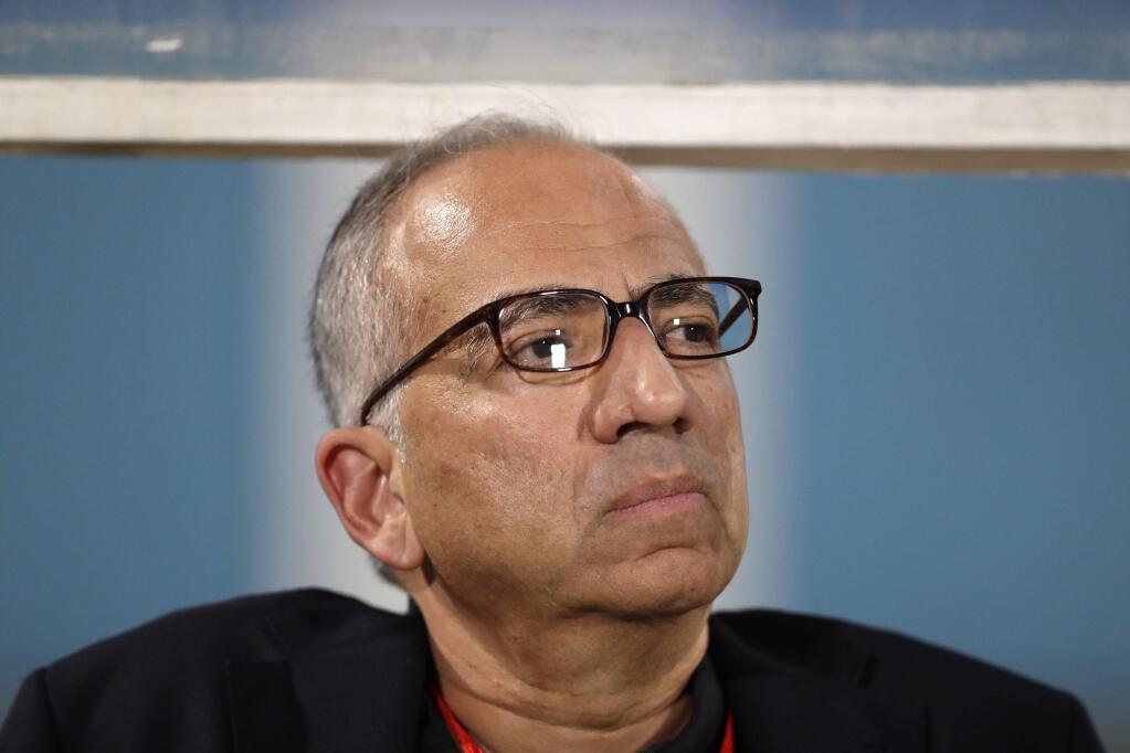 In this Oct. 10, 2017, file photo, Carlos Cordeiro, vice president of U.S. Soccer, watches warmups from the team bench ahead of the start of the U.S.'s final World Cup qualifying match against Trinidad and Tobago at Ato Boldon Stadium in Couva, Trinidad. (AP Photo/Rebecca Blackwell, File)