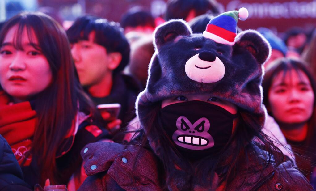 Fans wait for the medal ceremonies to begin at the 2018 Winter Olympics in Pyeongchang, South Korea, Tuesday, Feb. 20, 2018. (AP Photo/Charlie Riedel)