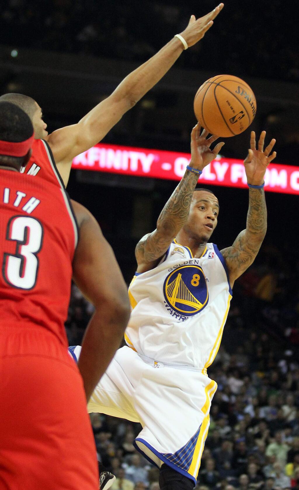 Golden State Warriors shooting guard Monta Ellis dishes off a pass against the Portland Trail Blazers during their game in Oakland on Wednesday night, January 25, 2012. (Christopher Chung/ The Press Democrat)