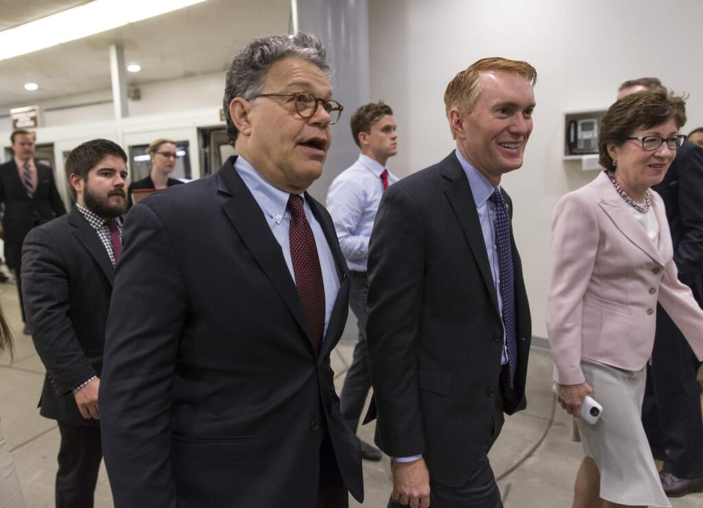 From left, Sen. Al Franken, D-Minn., Sen. James Lankford, R-Okla., and Sen. Susan Collins, R-Maine, rush to the Senate chamber on Capitol Hill in Washington, Wednesday, June 29, 2016, to vote as a rescue package for debt-stricken Puerto Rico, just two days before the island is expected to default on a $2 billion debt payment. (AP Photo/J. Scott Applewhite)