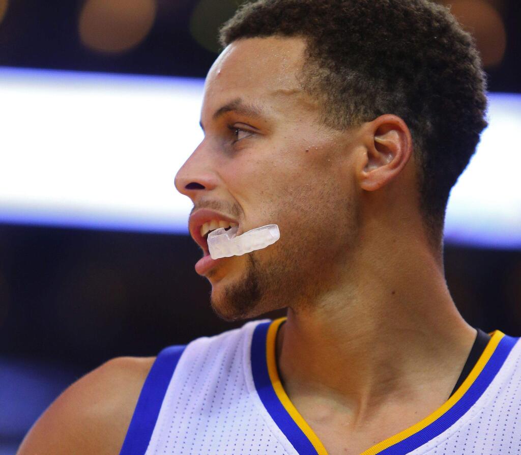 Warriors guard Stephen Curry chews on his mouthguard during the game against the Denver Nuggets, in Oakland, on Tuesday, October 13, 2015. (Christopher Chung/ The Press Democrat)