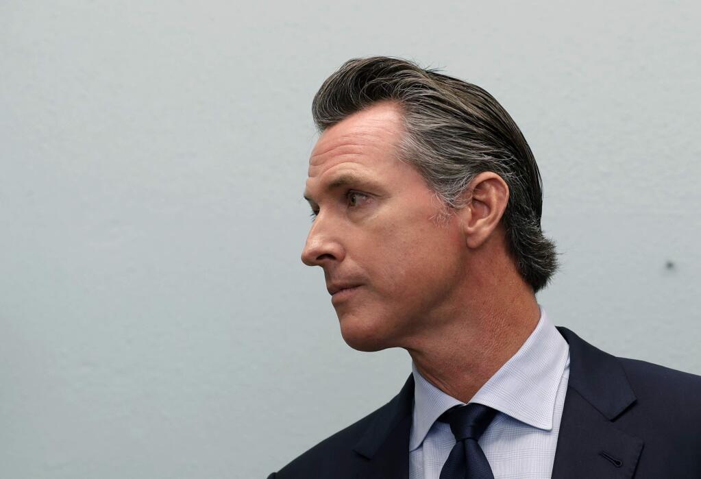 Governor-elect Gavin Newsom looks on during a news conference near the border Thursday, Nov. 29, 2018, in San Diego. (AP Photo/Gregory Bull)